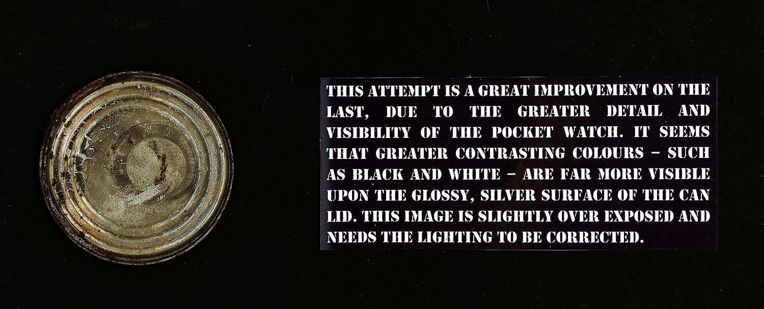 photograpph of tintype pocket watch on a tin can